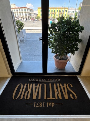 A hotel entrance with a doormat reading 'SANTURANO' and 'dal 1817'.