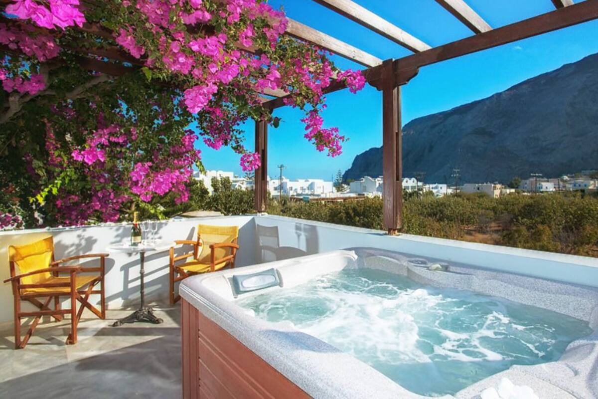 A hot tub with a view of a mountain and a cityscape.