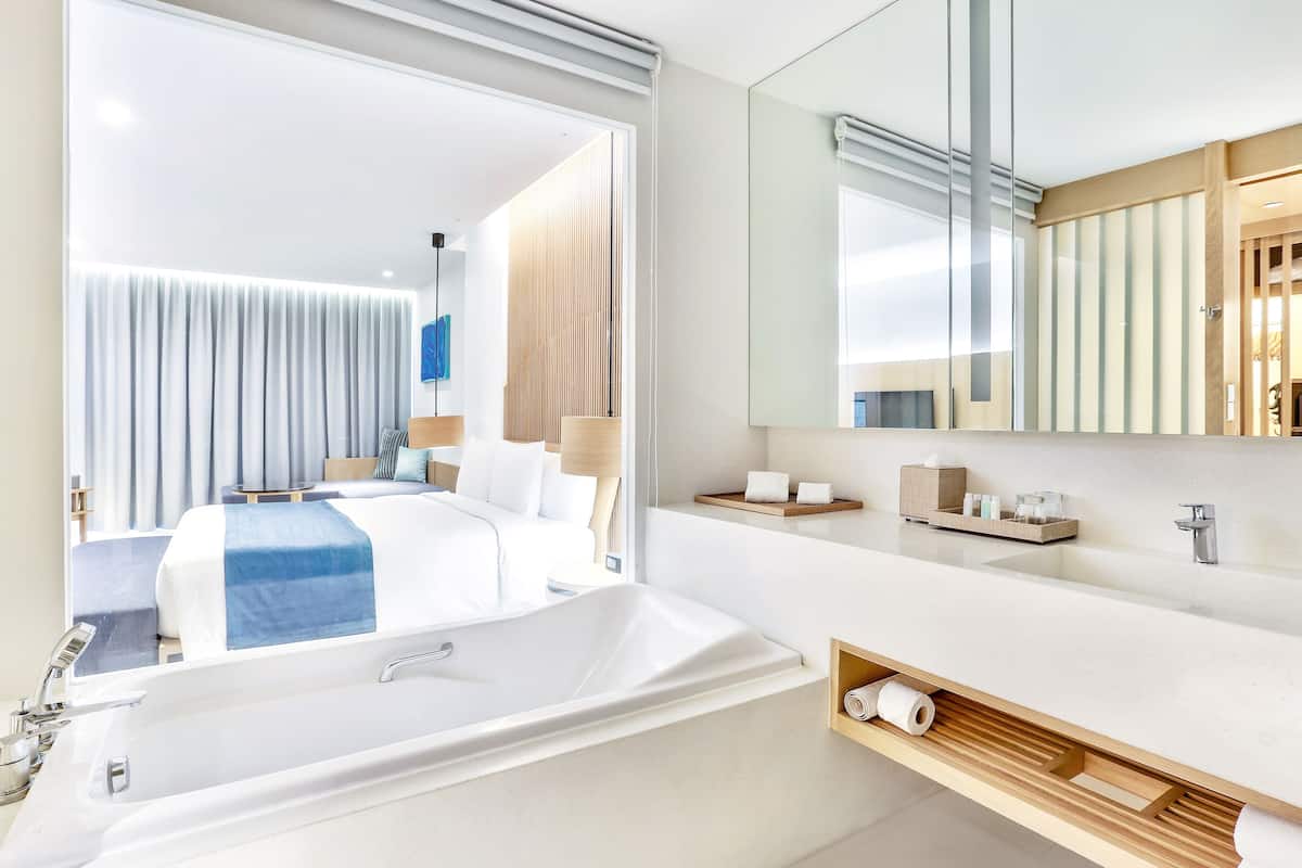 deluxe room | bathroom | separate bathtub and shower, designer toiletries, hair dryer, bathrobes