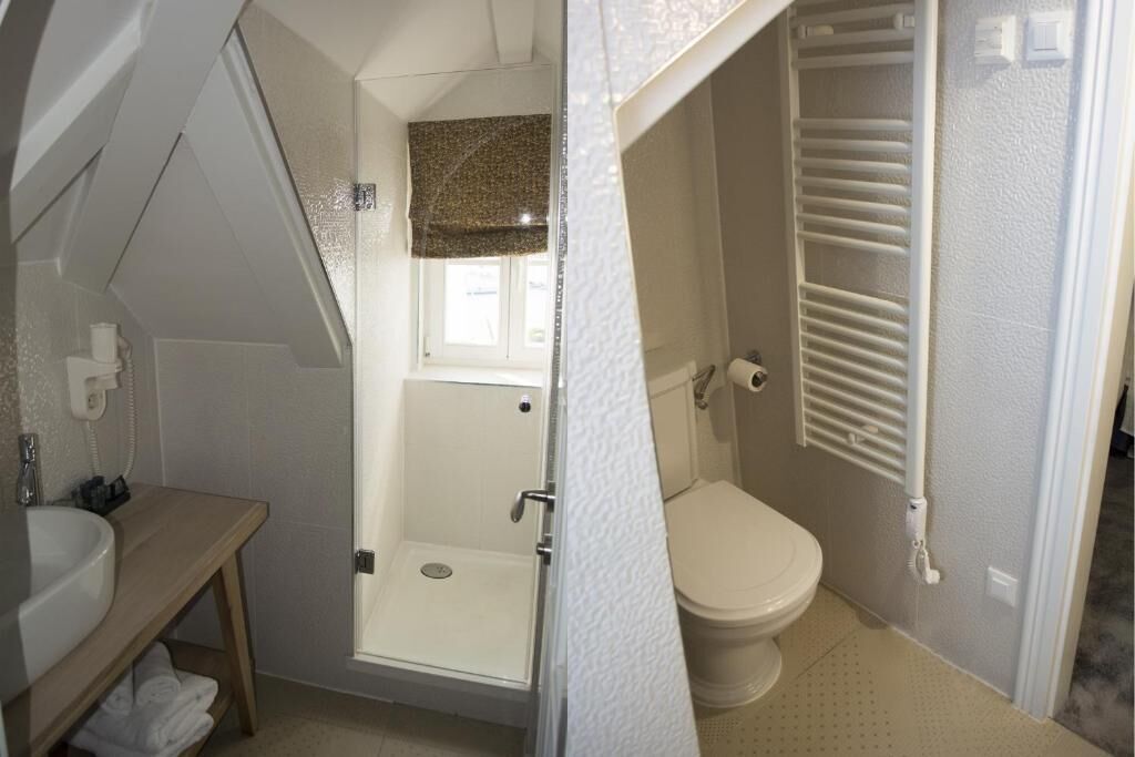 A compact bathroom with a shower, toilet, and sink.