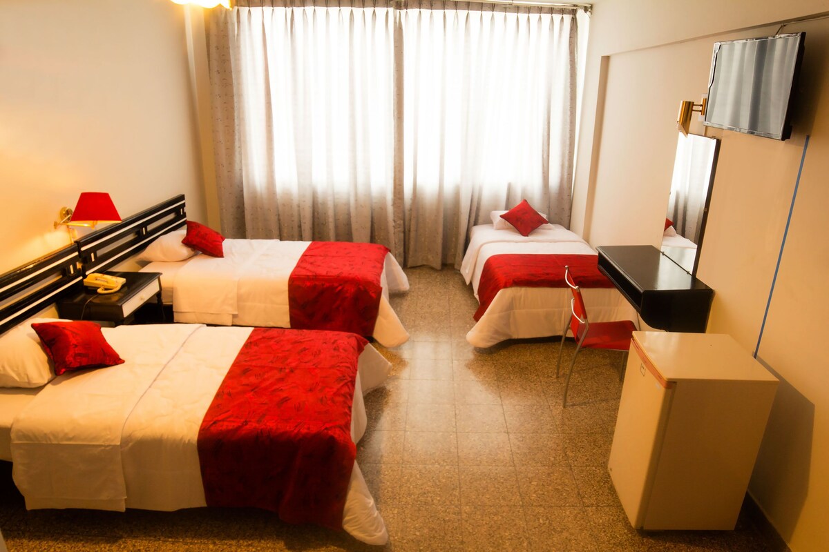 Triple Room | Minibar, in-room safe, desk, iron/ironing board