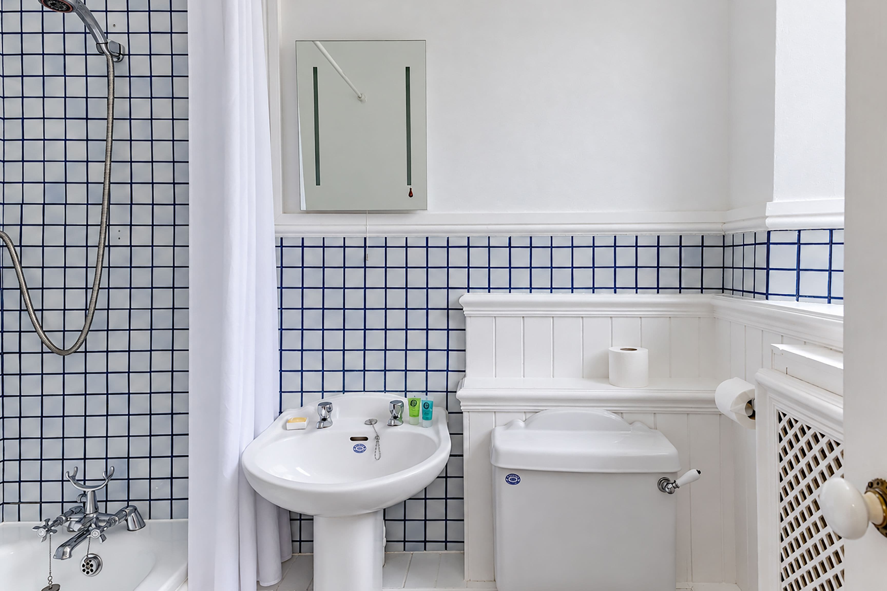 A bathroom with a bathtub, a sink, and a toilet.