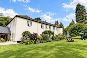A large, single-story building with a well-maintained lawn and picnic tables. - Nant Ddu Lodge Hotel & Spa by Belvilla (Merthyr Tydfil)