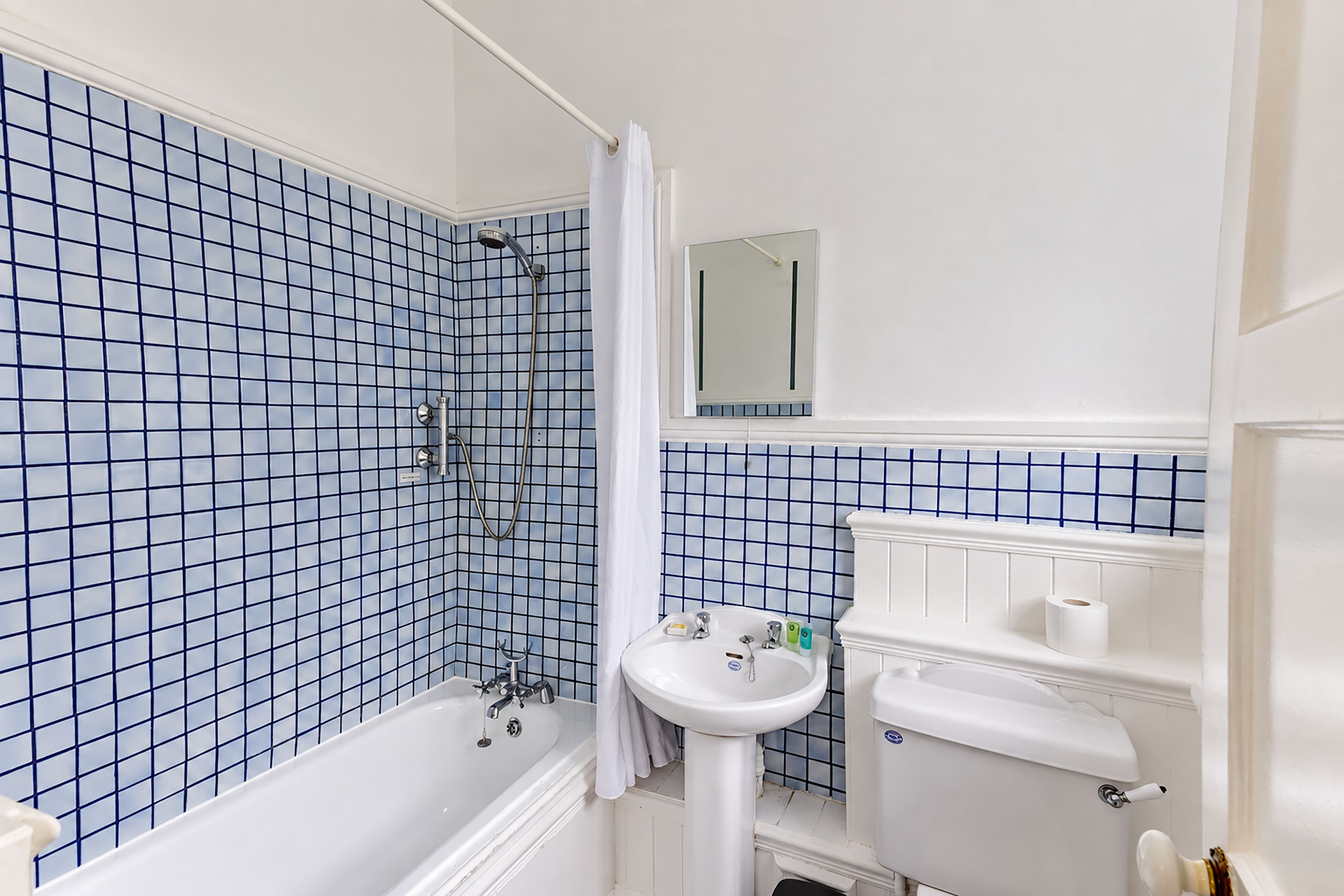 A bathroom with a bathtub, a sink, and a toilet.