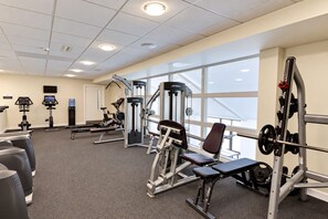 A gym with various exercise equipment, large windows, and a ceiling with recessed lighting. - Nant Ddu Lodge Hotel & Spa by Belvilla (Merthyr Tydfil)