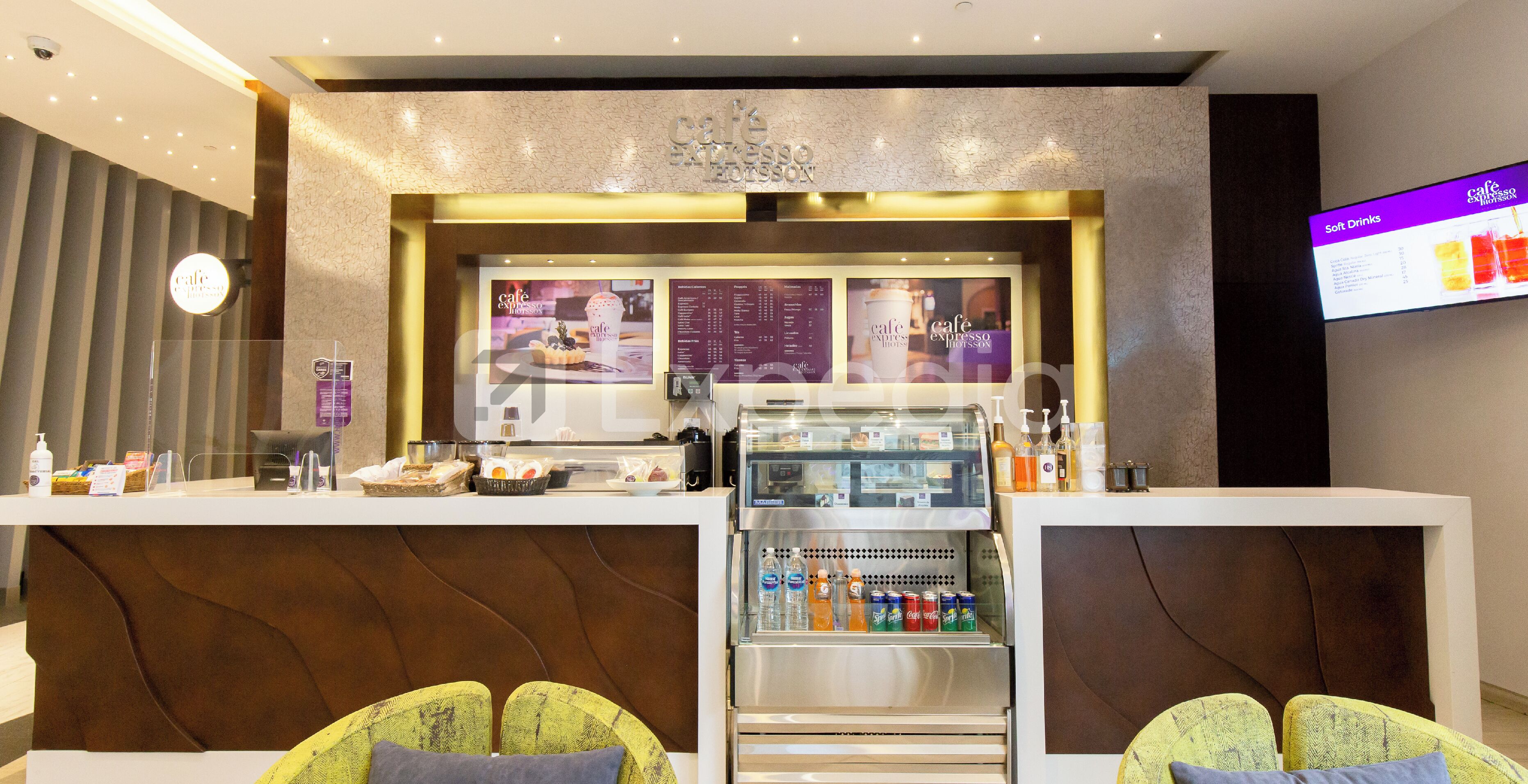 A cafe area with a counter, menu boards, and seating.
