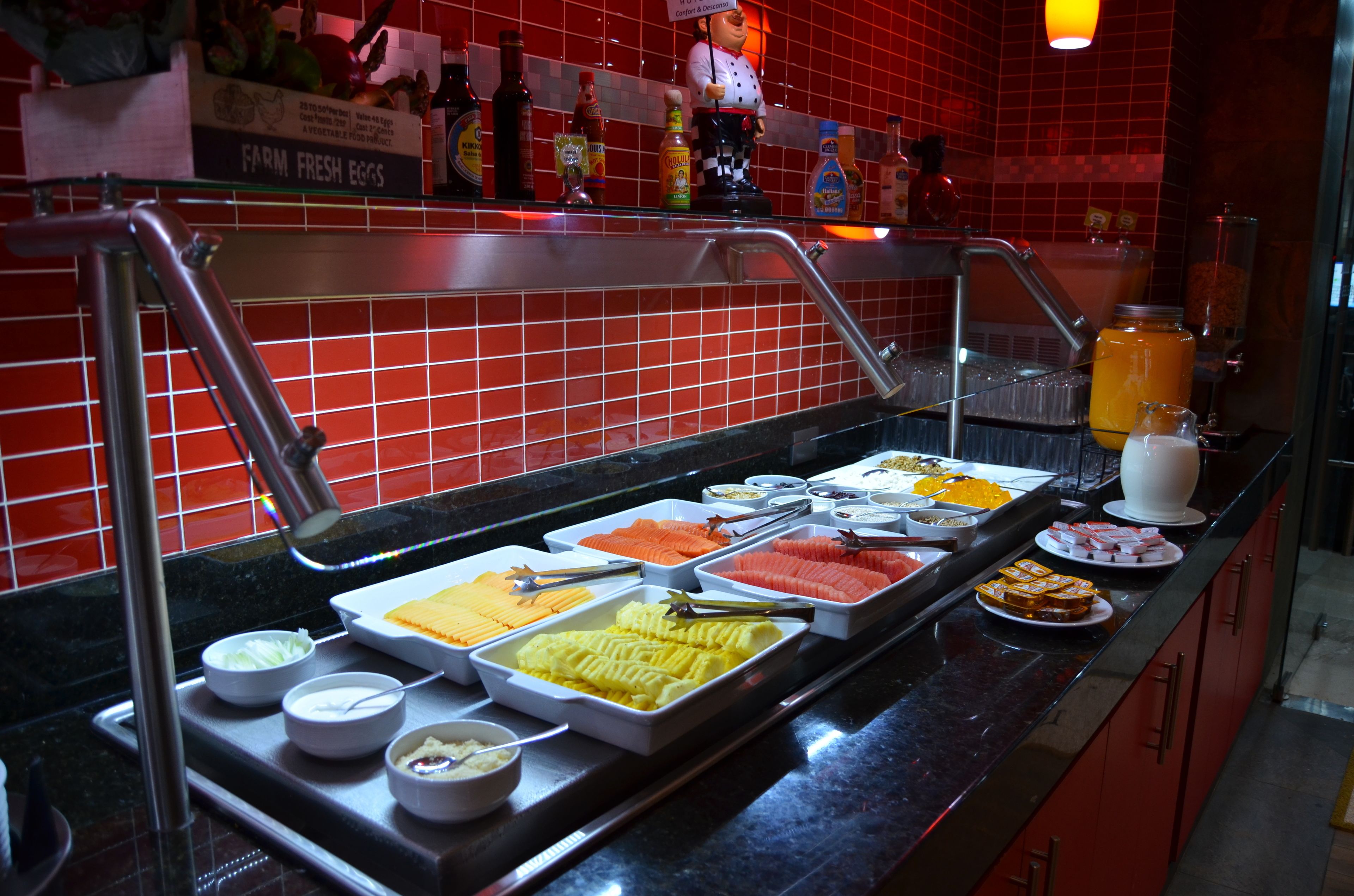 A buffet with various food items and condiments.
