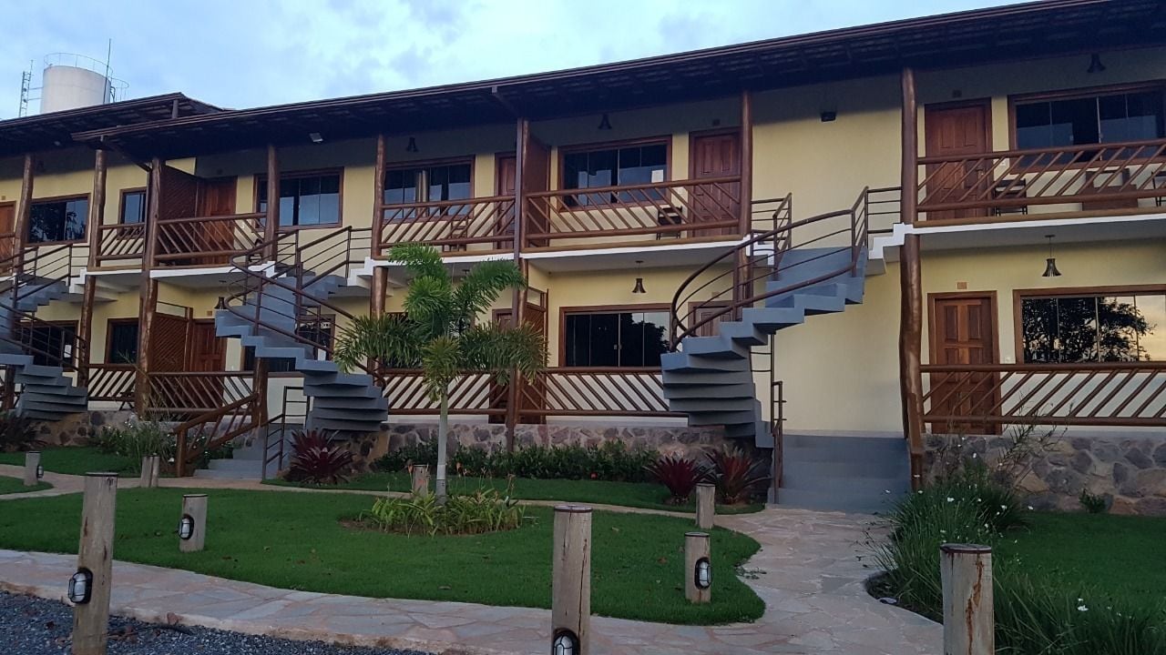 A multi-story building with wooden balconies and external staircases.