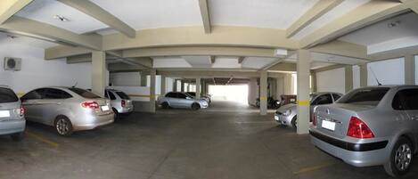 A multi-level parking garage with several cars parked.
