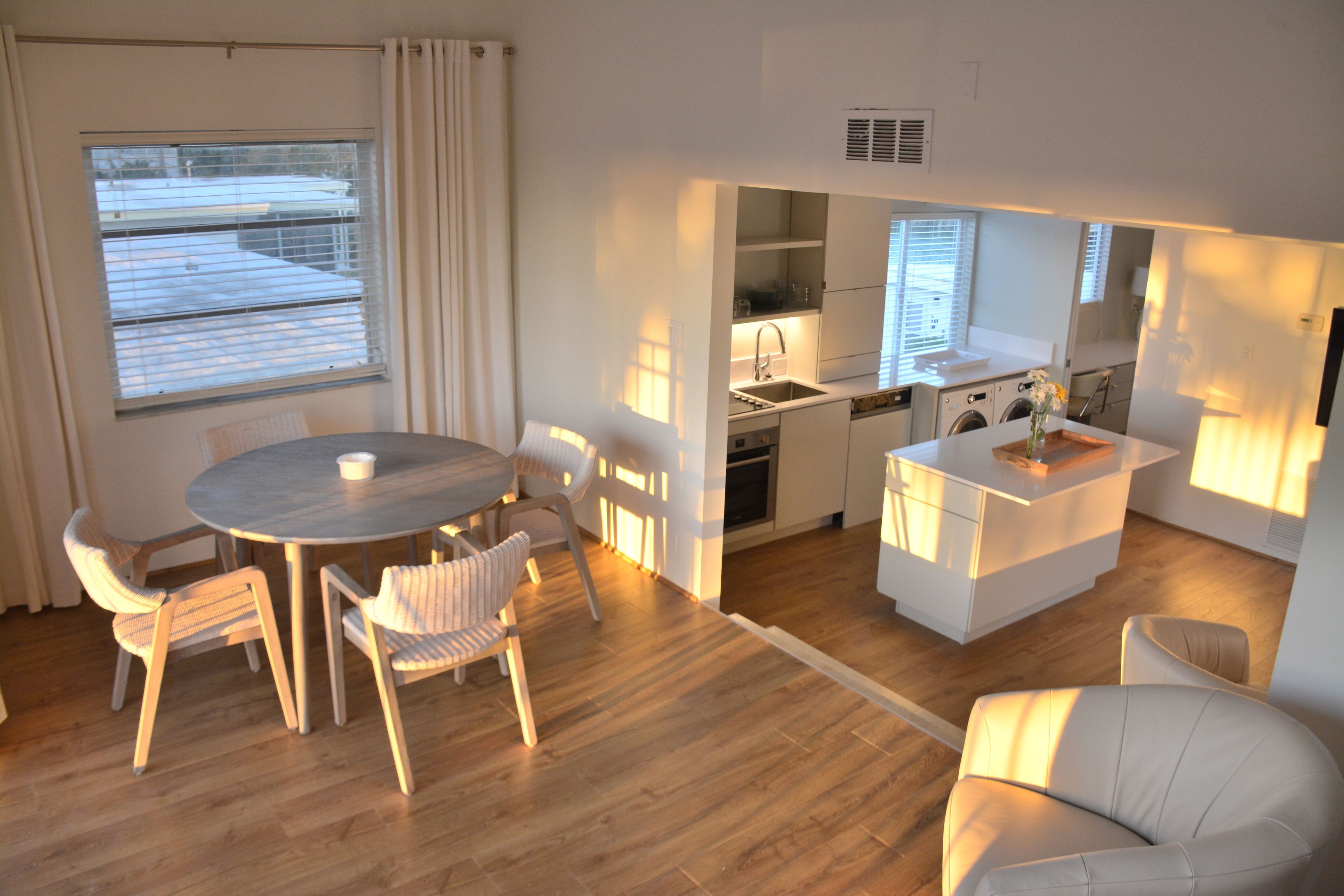 A compact living space with a dining area, kitchen, and seating.