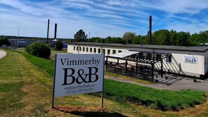 A sign for Vimmerby B&B with a contact number and website.
