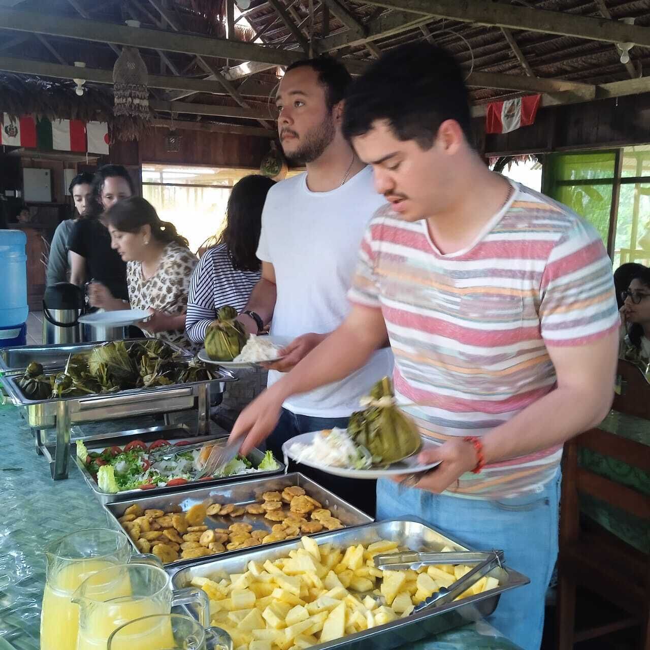 A buffet setup with various food items and beverages.