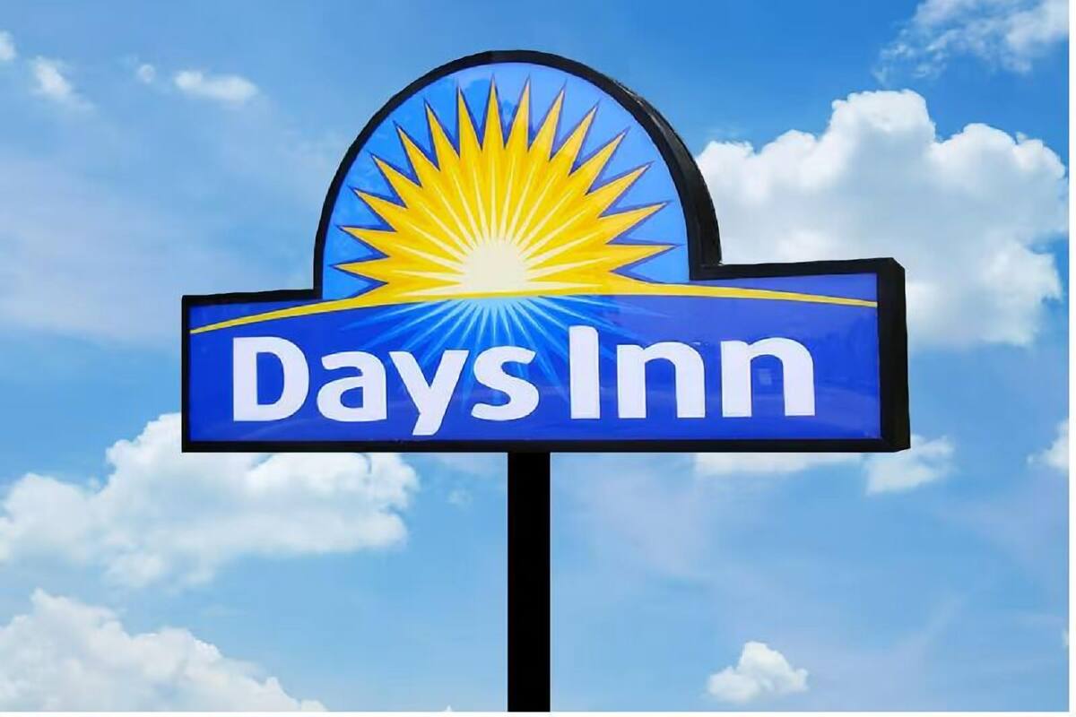 A Days Inn sign with a sun graphic and the name 'Days Inn' on a blue background.