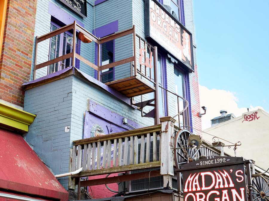 A multi-story building with a restaurant and bar named "Madam's Organ" on the ground floor.