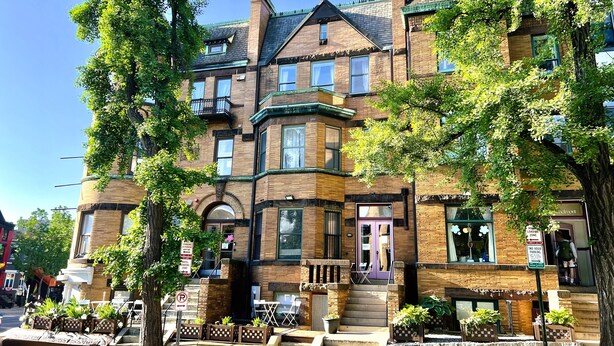 A Victorian-style building with a brick facade, multiple windows, and a prominent entrance with steps. - HighRoad Washington DC (Washington)