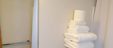 A bathroom with a sink, mirror, towel rack, and toilet.