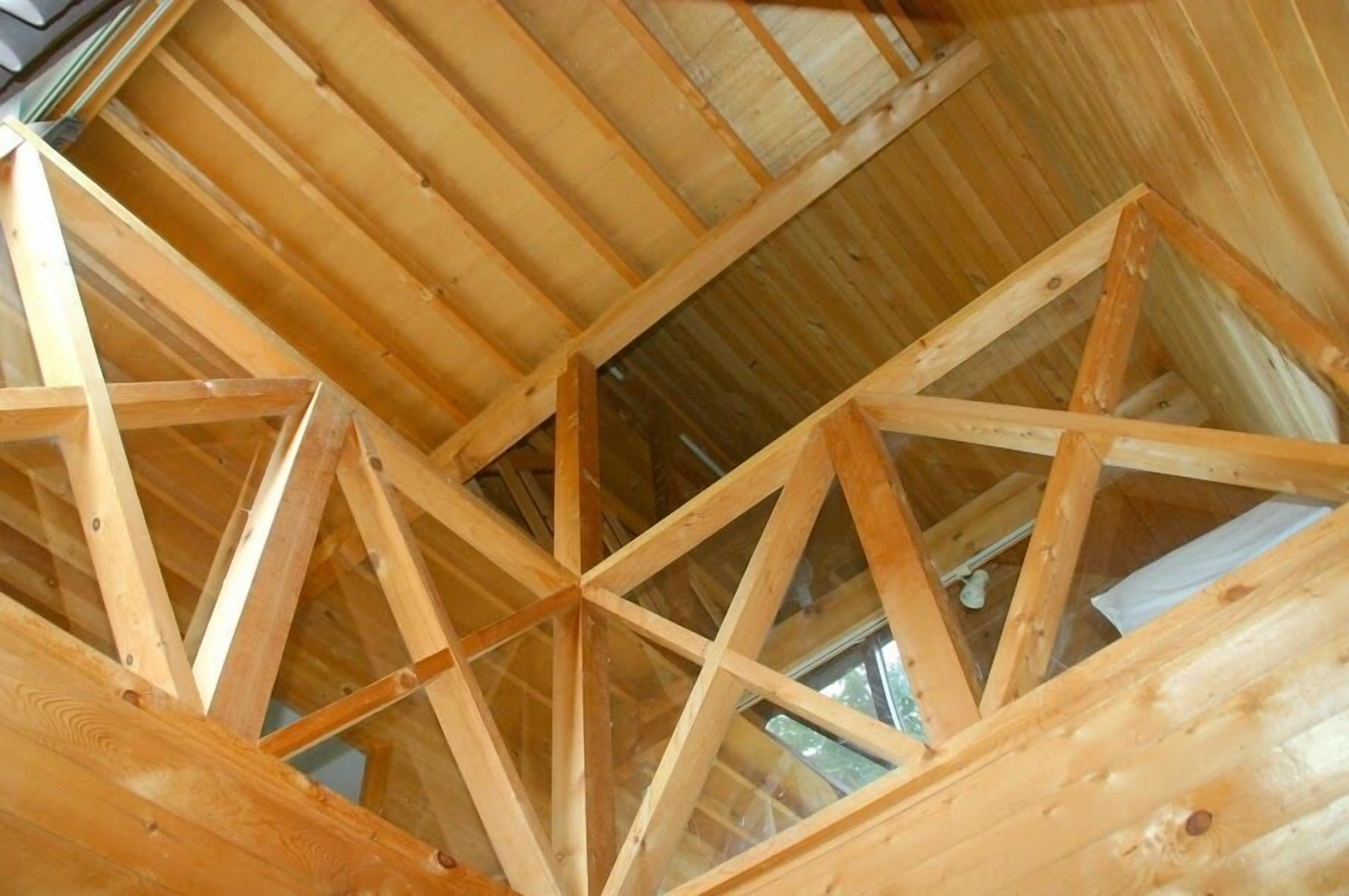 A wooden truss ceiling structure in a building.