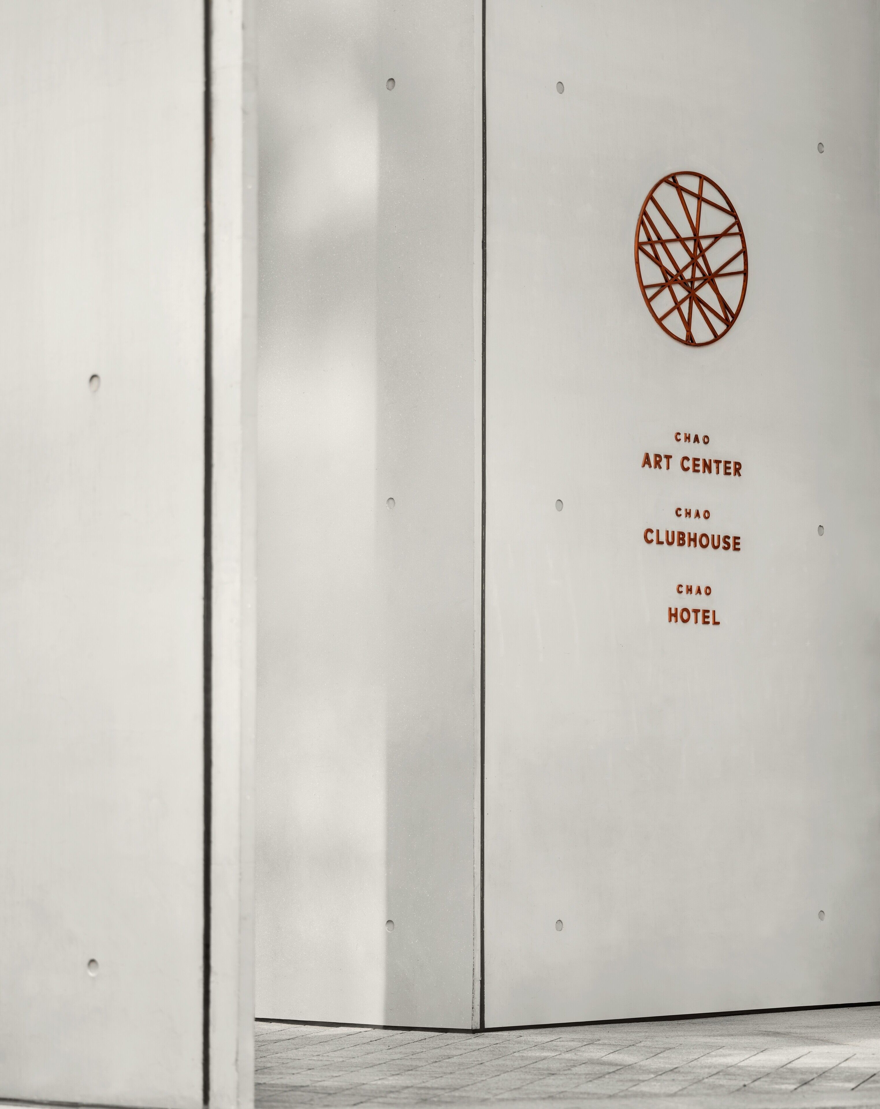A wall with a geometric design and text indicating "Chao Art Center," "Chao Clubhouse," and "Chao Hotel."