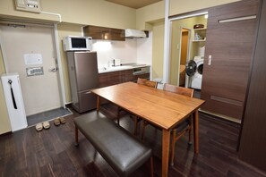 A compact kitchen with a microwave, oven, and built-in washing machine.