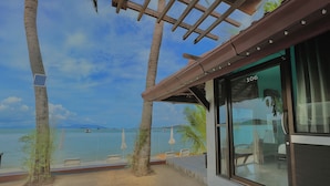 A beachside room with a view of the sea, a pergola, and a number 106 sign. - The Shore Samui (Koh Samui)