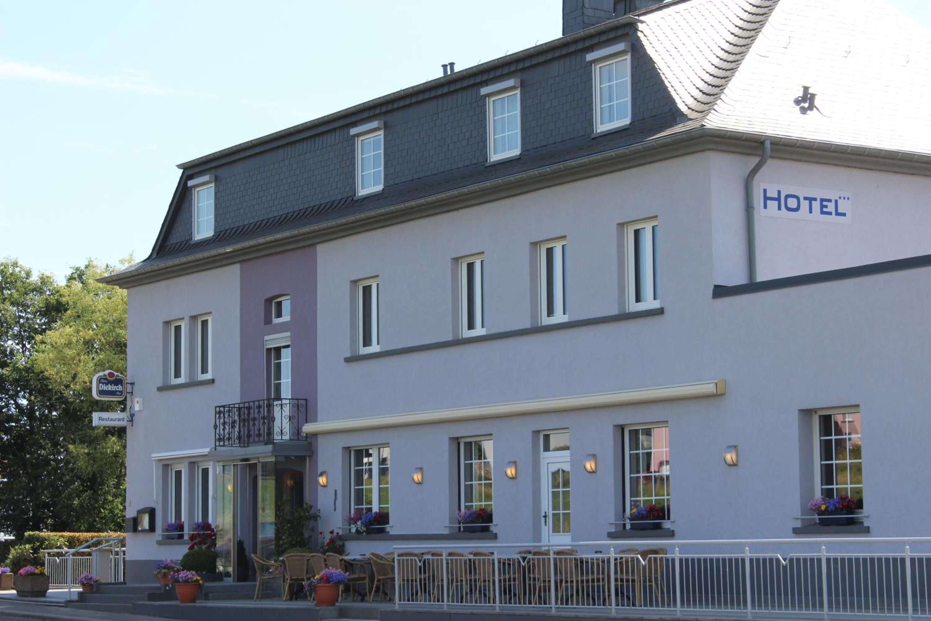 A two-story building with a sign indicating it is a hotel.