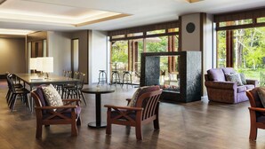 A spacious room with a dining area, seating, and a fireplace.