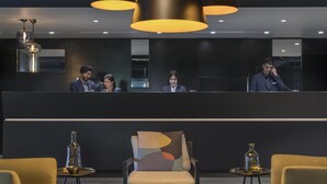 A modern hotel lobby with a reception desk, seating area, and contemporary decor. - Oaks Melbourne Southbank Suites (Southbank)