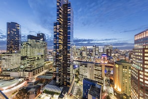 Un immeuble de grande hauteur doté d’une façade moderne en verre, entouré d’autres bâtiments imposants au cœur d’un paysage urbain.