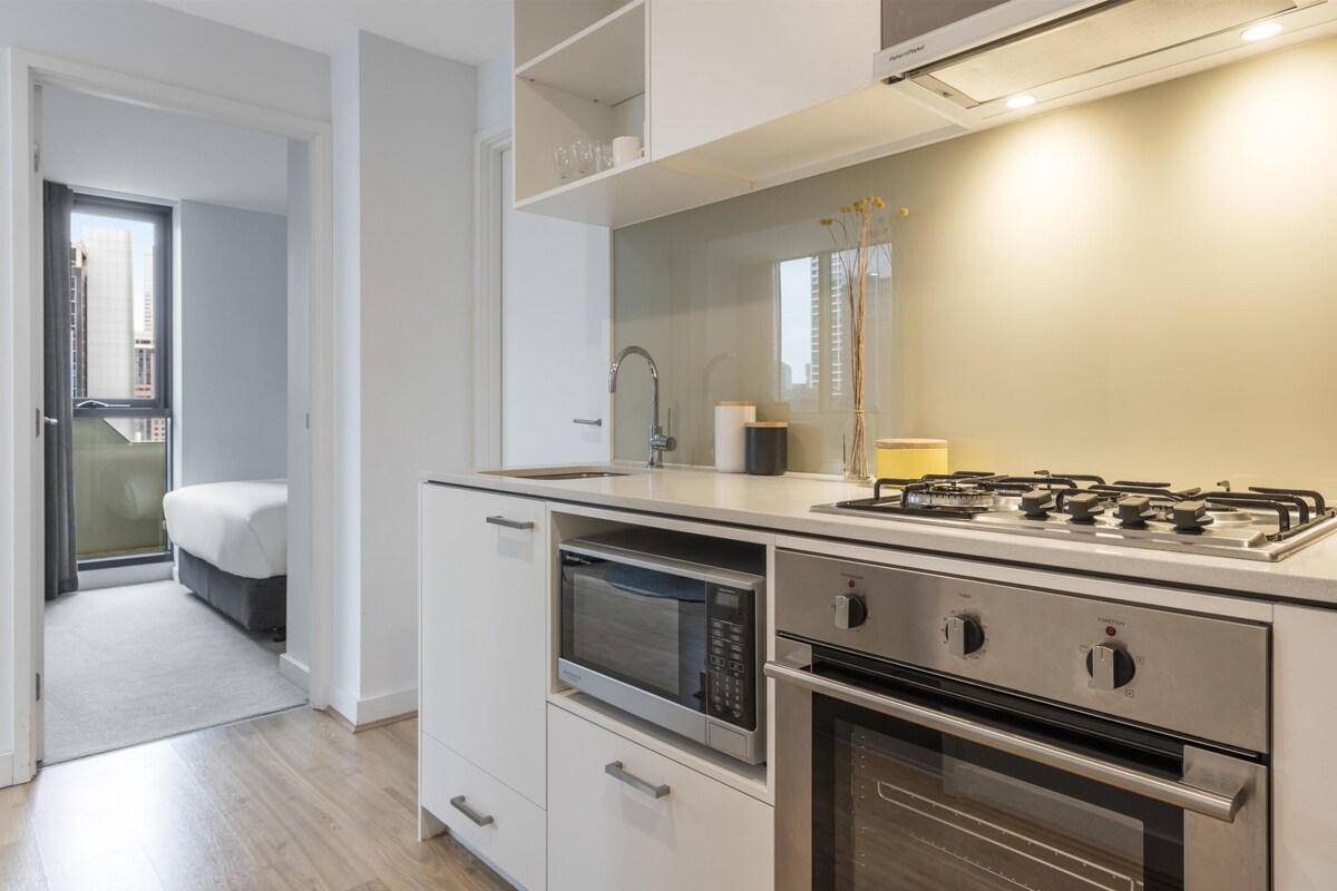 Une cuisine moderne dotée d’appareils électroménagers intégrés, un coin repas et une chambre avec vue.