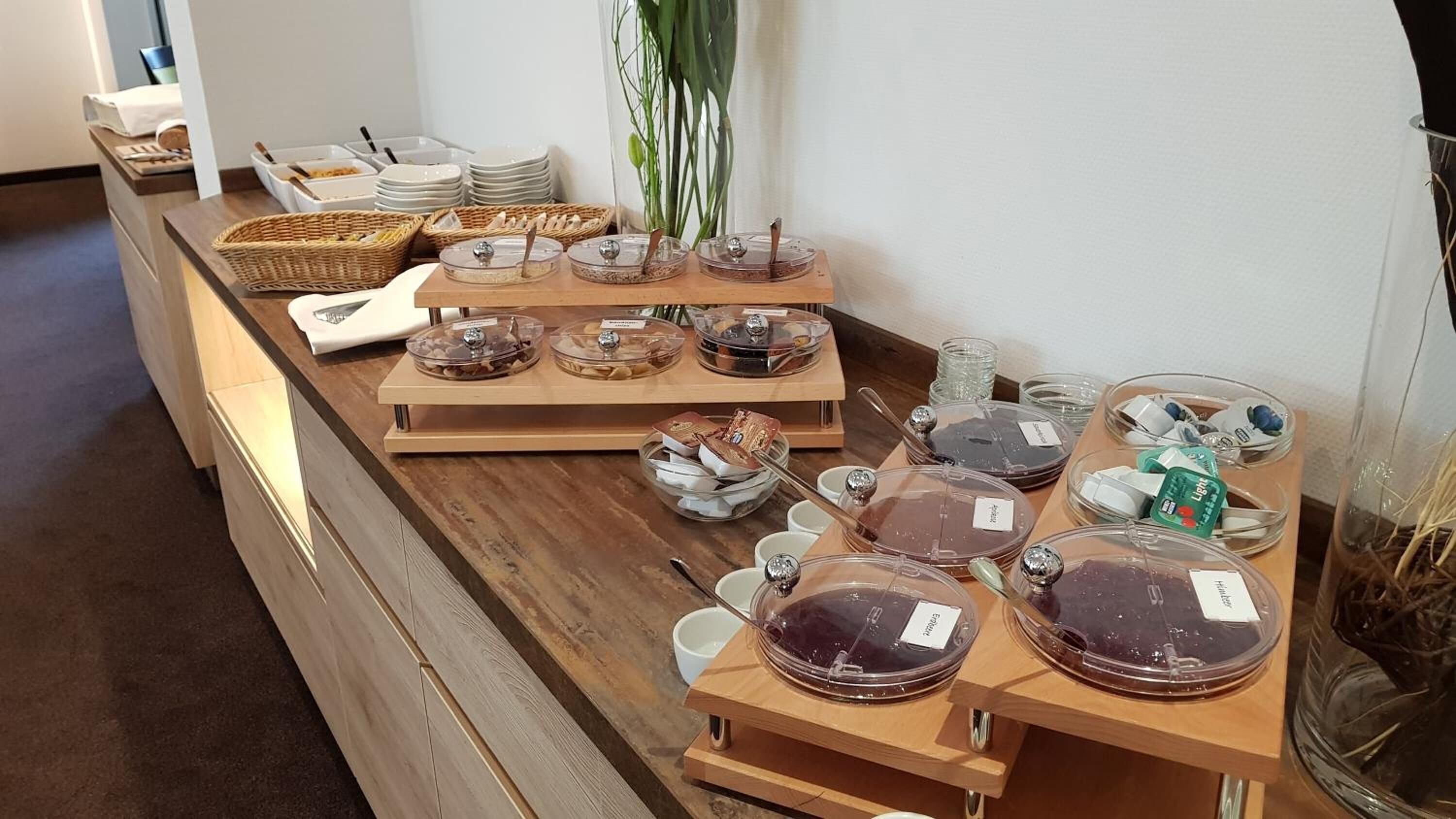 A buffet setup with various food items and containers.
