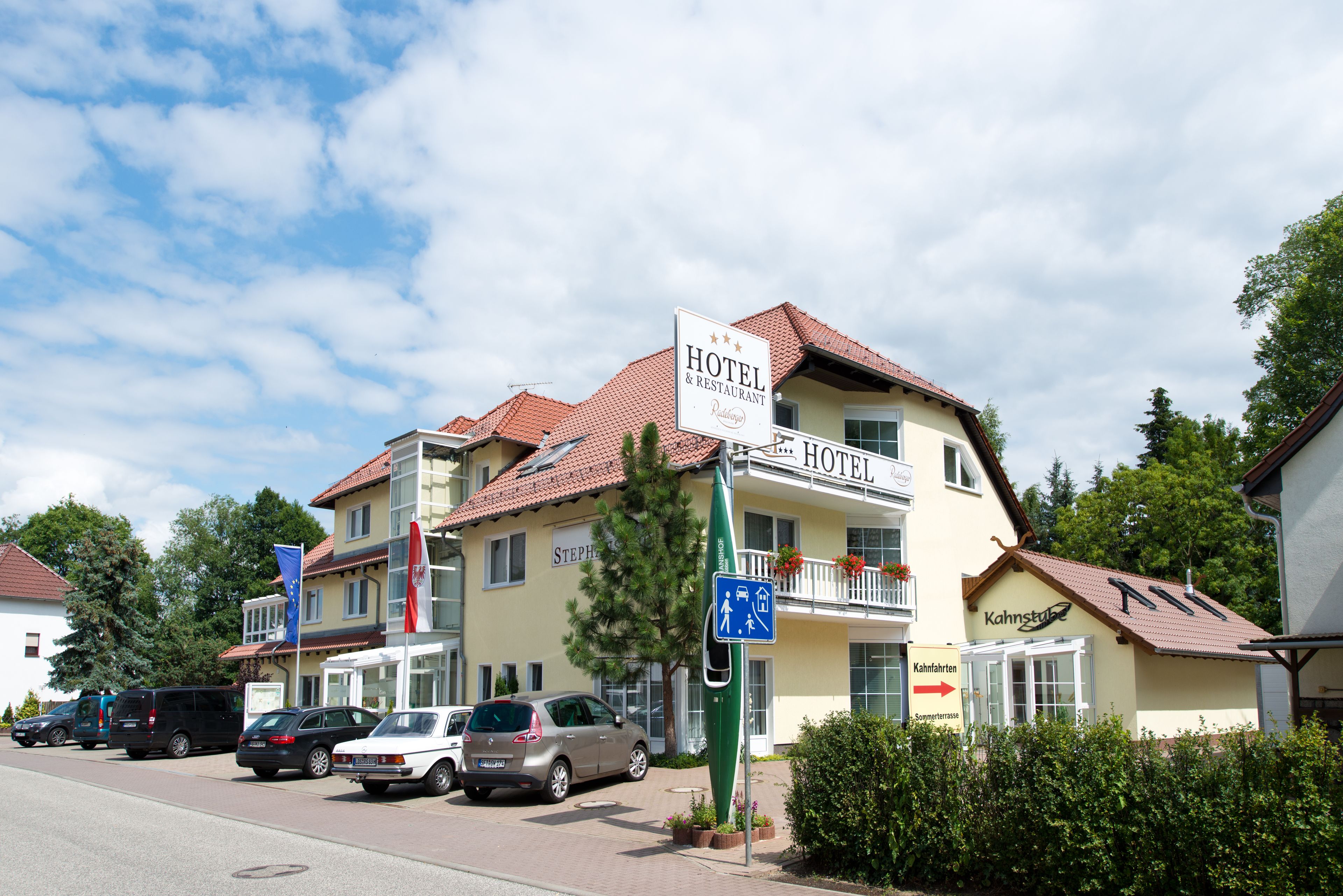 A hotel with a sign indicating "HOTEL & RESTAURANT" and a directional sign pointing to "Kahnstub".