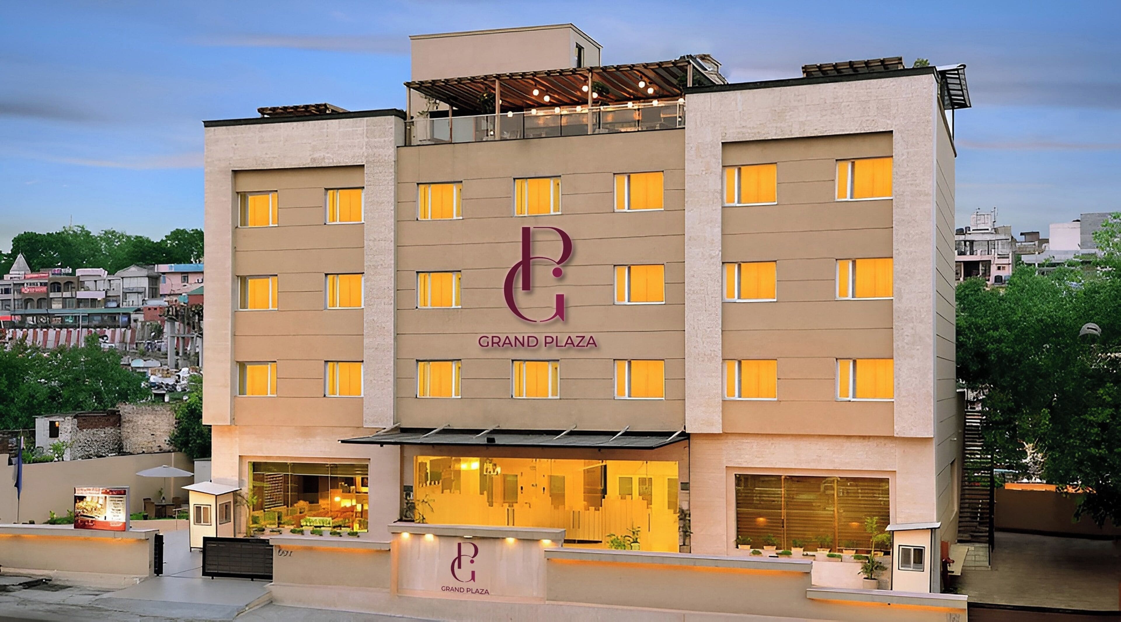 A hotel with a prominent 'Grand Plaza' sign, multiple windows, and a visible entrance with a reception desk.