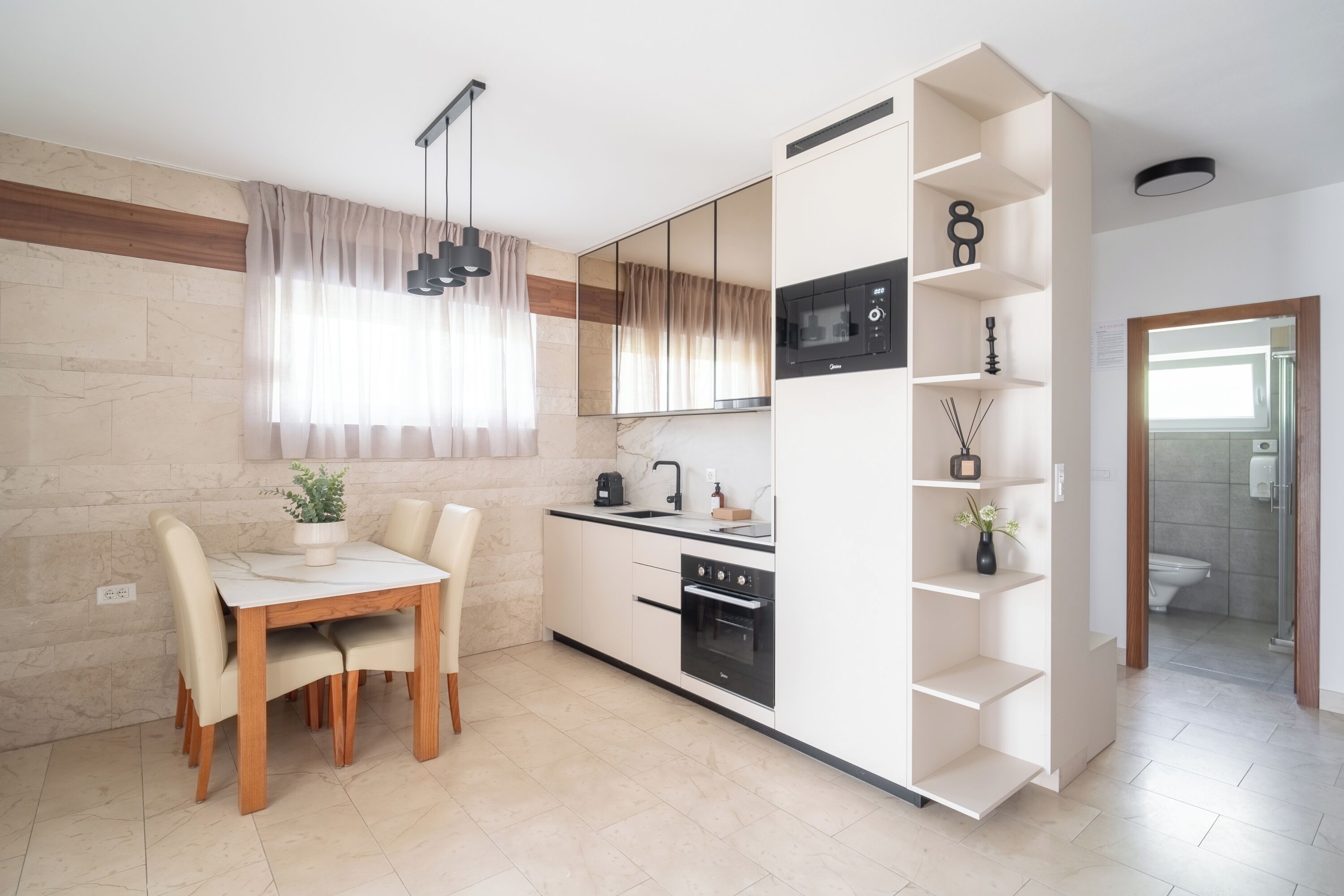 Una cucina moderna con zona pranzo, forno integrato e microonde.