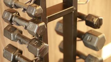A rack of dumbbells with adjustable weights.