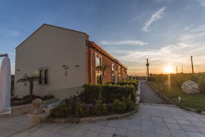A building with a modern architectural style, featuring a flat facade and large windows. - Palascia Wellness Relais (Otranto)
