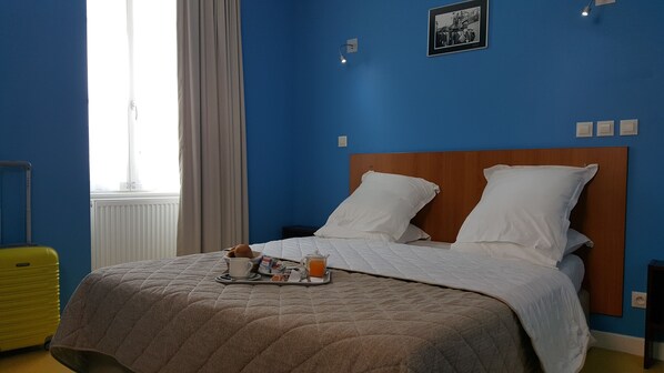 A hotel room with a bed, a tray with breakfast items, a suitcase, and a window with curtains. - L'étape de Santenay (Santenay)