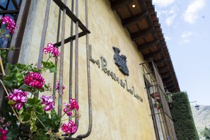 A building facade with a sign reading "La Posada de La Loma." - Posada de Los Leones (Antigua Guatemala)
