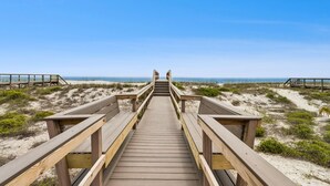 A wooden boardwalk leading to a beach with clear skies. - Relaxed Atmosphere in S Fletcher Duplex by RedAwning (Fernandina Beach)