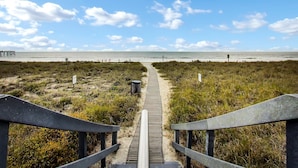 A wooden boardwalk leading to a beach with a clear sky and scattered clouds. - Amelia South 2 Bedroom Condo by RedAwning (Fernandina Beach)
