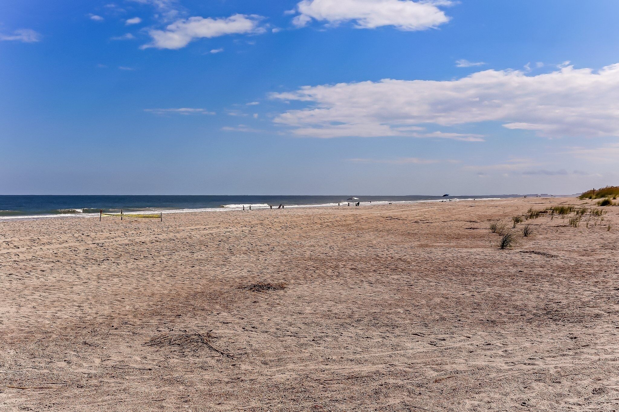 A beach with a clear sky and calm sea.