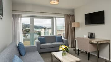 Apartment, 2 Bedrooms | Living area | Flat-screen TV, iPod dock, first-run films