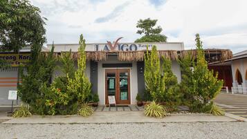A building with a sign reading "LAVIGO Resort" and two doors labeled "WELCOME" and "RECEPTION".