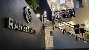 The exterior of Rangya Hotel with a sign indicating a coffee shop soon to open.