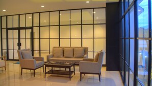 A modern living room with a sofa, armchairs, and a coffee table.