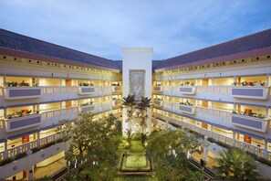 A multi-story hotel with balconies, a central courtyard, and a pool. - Puri KIIC Golf View Hotel (Karawang)