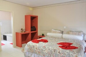 Relax in comfort with a large bed, wardrobe, and cozy seating area.