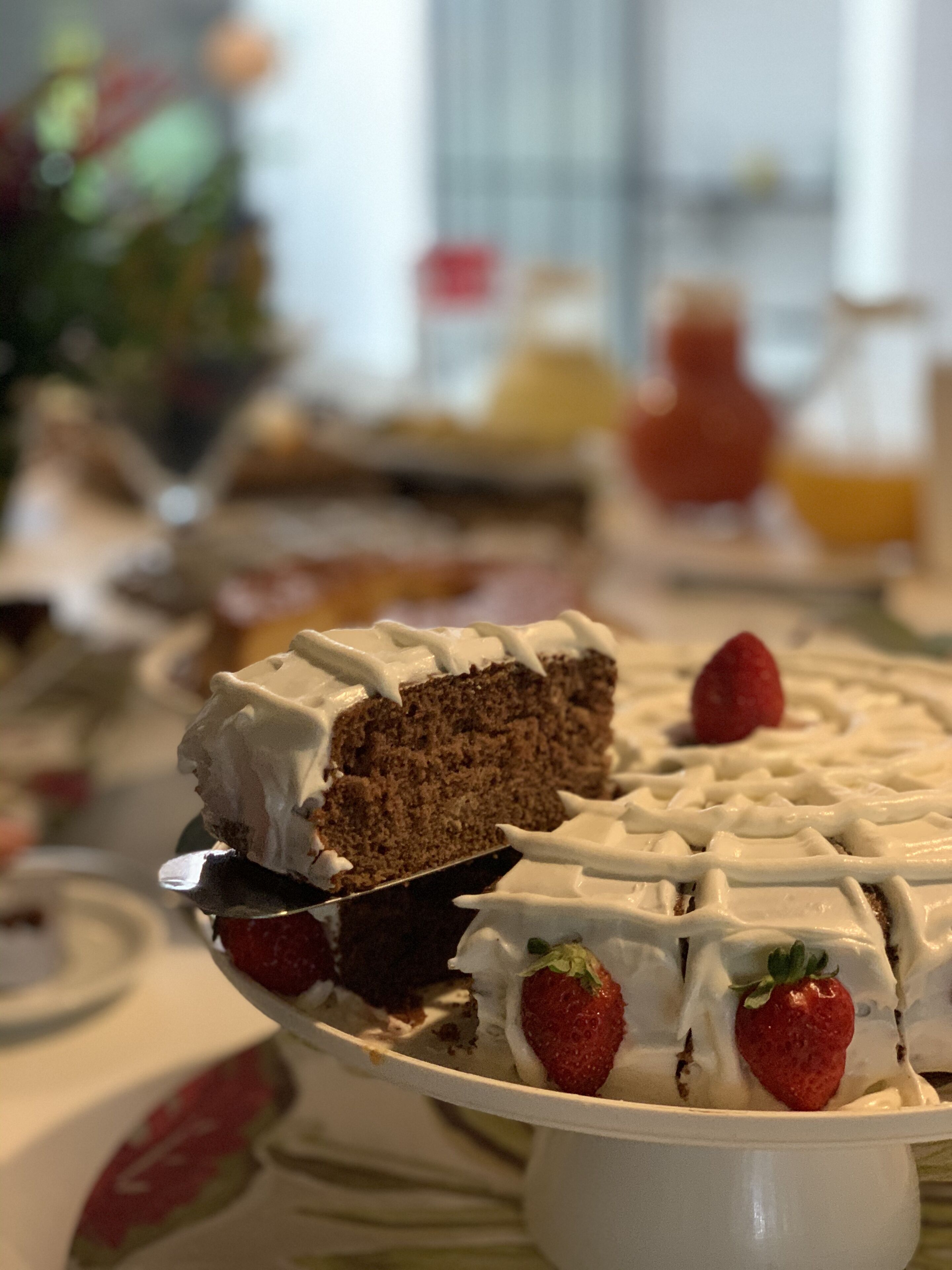 A slice of cake with strawberries on a white plate.