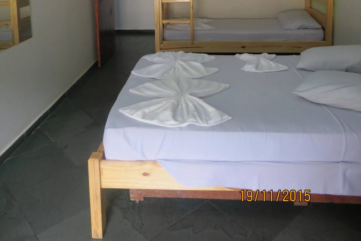 A bunk bed room with a TV on the wall, a door, and a date stamp.