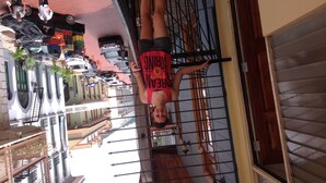 A person hanging upside down on a metal bar. - Voyager Int'l Hostel Panamá City (Panama City)