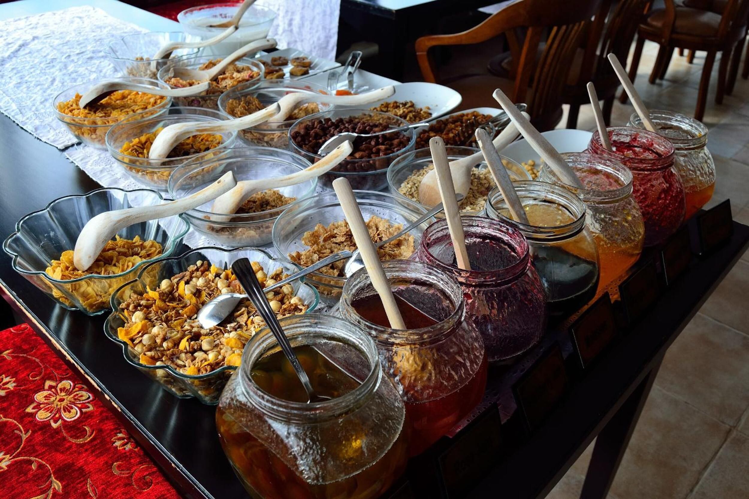 A buffet table with various food items and drinks.